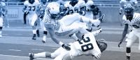 Football players in action on field